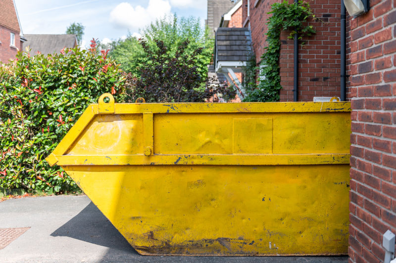 Yellow skip next to house