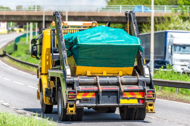 Skip lorry in transit