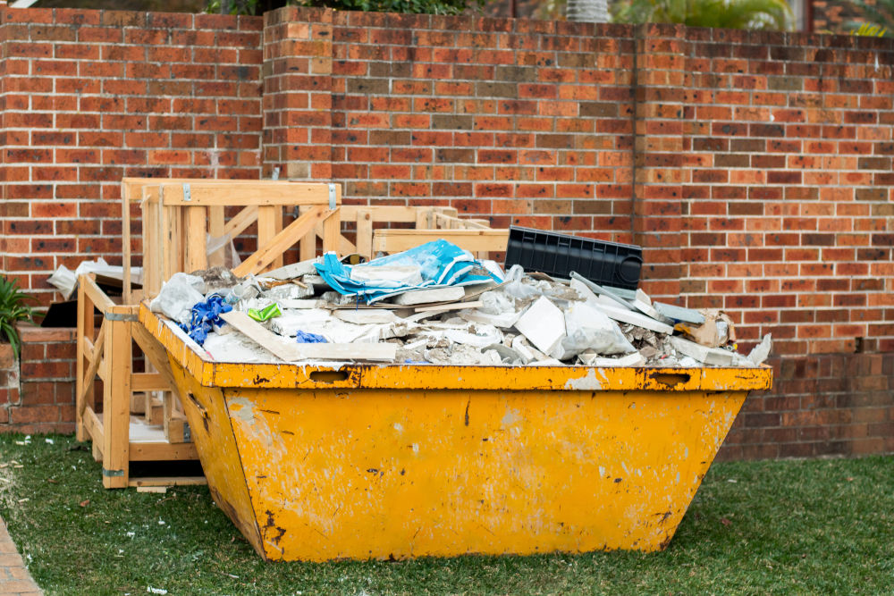 Waste Filled Yellow Skip on Grass
